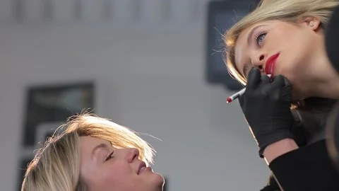 Microblading lip tattooing with a special coloring pigment corrects the color of Stock Footage 264072914