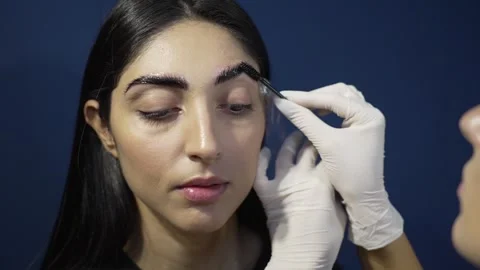Microblading Magic: Brushing and Oiling the Perfect Brows Closeup of Young Stock Footage 291316709