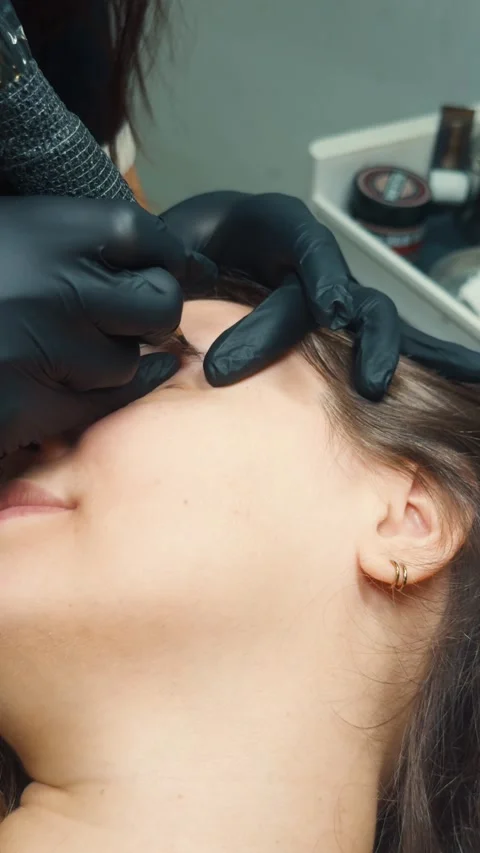 Microblading procedure creating natural looking hairstrokes, enhancing eyebrows, Video stock 331574402