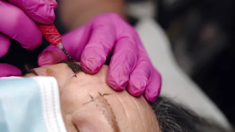 Microblading procedure for middle-aged woman in beauty salon Video stock 163358804