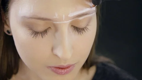 Microblading. Young girl doing the procedure of eyebrow coloring at the spa Stock Footage 106224817