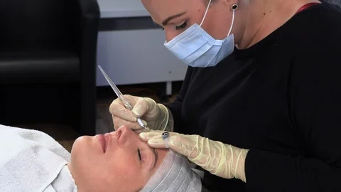 Microblading,Woman having eyebrows drawn and tinted with pencil. Stock Footage 113673379