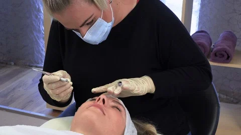 Microblading,Woman having eyebrows drawn and tinted with pencil. Stock Footage 113734341