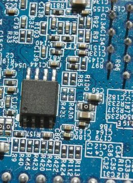 Microchip and components on blue electronic pcb closeup Stock Photos