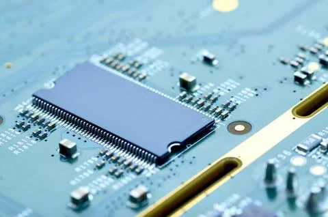 Microchip and electronic components on the board close-up Stock Photos