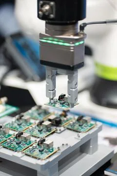Microchip and microprocessor assembly with automated robotic arm factory Stock Photos