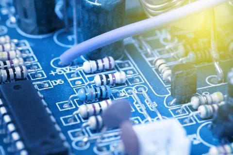 Microchip, capacitors, resistors on a blue computer board. Industrial backgro 스톡 사진