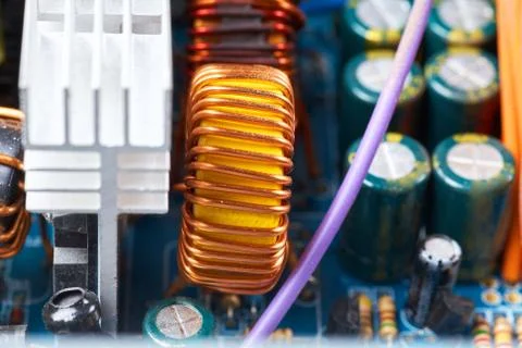 Microchip, capacitors, resistors on a computer board. Industrial background. Stock Photos