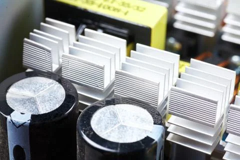 Microchip, capacitors, resistors on a computer board. Industrial background. Stock Photos