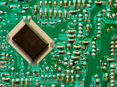 Microchip on the control board of modern electronic equipment. Stock Photos