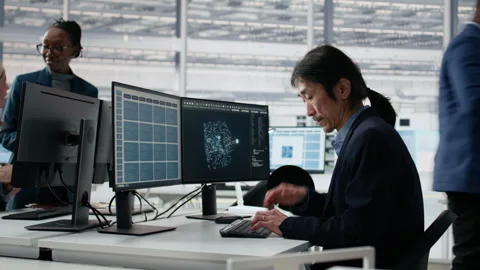 Microchip facility senior manager using AI to examine semiconductor substrates Stock Footage 335881830