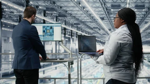 Microchip factory employees using AI deep learning tech to develop electronics Stock Footage 333380748