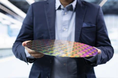 Microchip factory manager looking at microelectronic semiconductor substrate Stock Photos