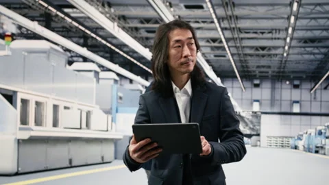 Microchip factory senior manager testing silicon wafer batches with tablet Stock Footage 333394890