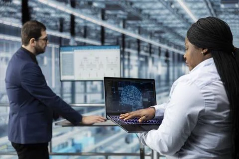Microchip factory workers optimize production lines with artificial intelligence Stock Photos