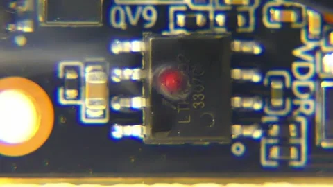 A microchip on an intricate circuit board is burnt due to over-voltage Stock Footage 289824413