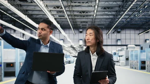 Microchip manufacturing plant multiethnic engineering team tracks semiconductors Stock Footage 333392675