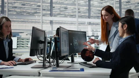 Microchip RD factory professionals reviewing production using AI assistant Stock Footage 335879544