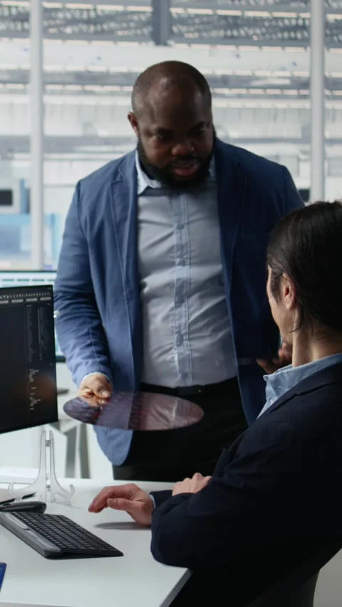 Microchip RD factory professionals reviewing production using AI assistant Stock Footage 335883112