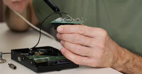 Microchip soldering close-up skilled hands carefully join components with Stock Footage 305773724