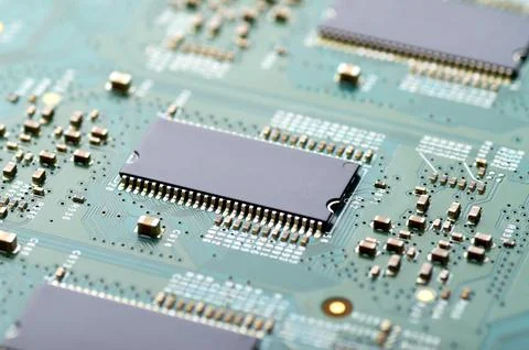Microchips and electronic components on the board close-up Stock Photos