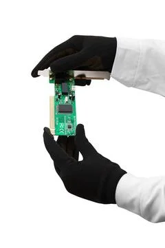 Microcircuit Hands with gloves hold chip on white Copyright: xZoonar.com/R... 写真素材