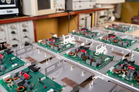 Microcircuits and components lie on metal plates Stock Photos