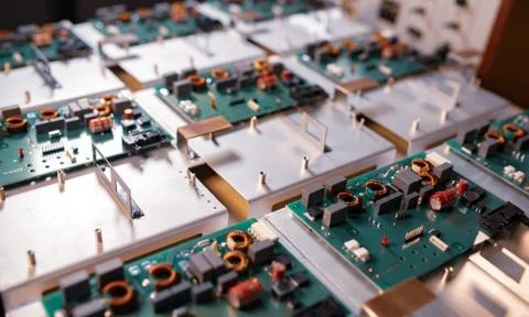 Microcircuits and components lie on metal plates Stock Photos