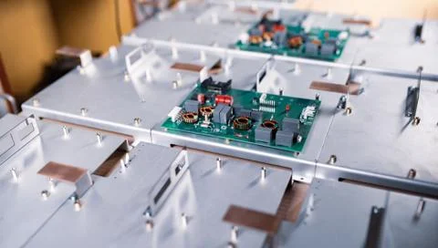 Microcircuits and components lie on metal plates Stock Photos
