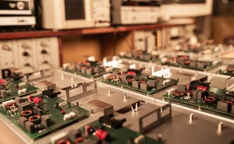 Microcircuits and components lie on metal plates Stock Photos