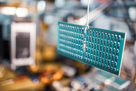 Microcircuits and components lie on metal plates Stock Photos