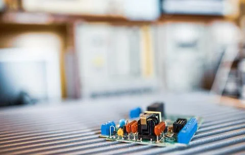 Microcircuits and components lie on metal plates Stock Photos