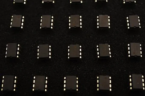Microcircuits on black foam. Multiple chips on a substrate. Stock Photos