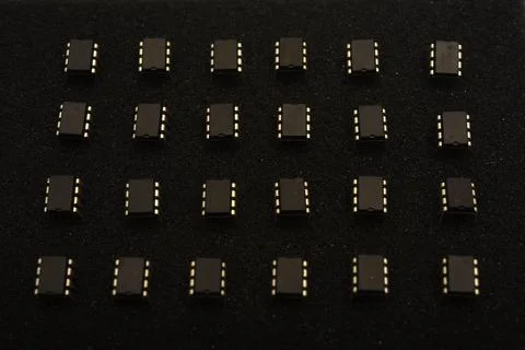 Microcircuits on black foam. Multiple chips on a substrate. Stock Photos