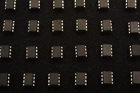 Microcircuits on black foam. Multiple chips on a substrate. Stock Photos