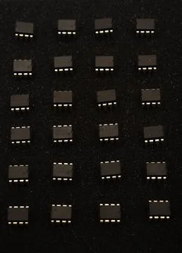 Microcircuits on black foam. Multiple chips on a substrate. Stock Photos