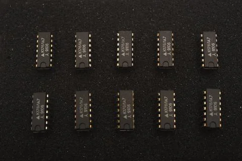 Microcircuits on black foam. Multiple chips on a substrate. Stock Photos