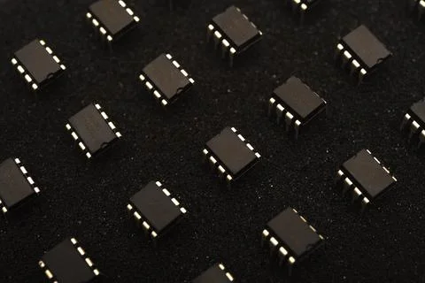Microcircuits on black foam. Multiple chips on a substrate. Stock Photos