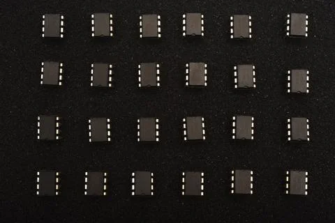 Microcircuits on black foam. Multiple chips on a substrate. Stock Photos