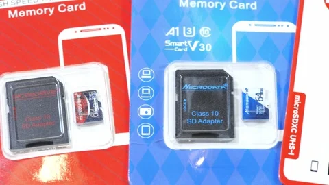 Microdrive and Taimi 64 GB microSD memory cards with SD adapters in colorfu.. Stock Footage 339372723