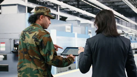 Microelectronics production factory manager and soldier brainstorm Stock Footage 333395270