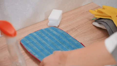 Microfiber cloth mop cleaning process. Janitor uses squeegee for spotless Stock Footage 345540269