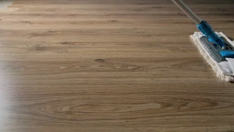Microfiber mop for cleaning laminate flooring. Close-up. Regular house cleaning. Stock Footage 246377152