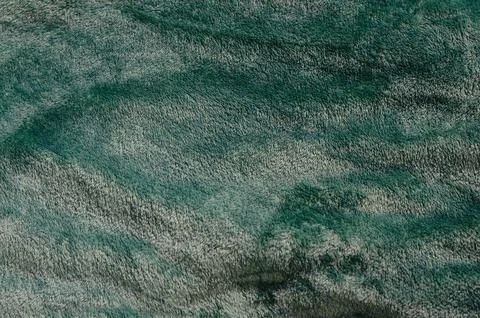 Microfiber texture with folds and reflections. Turquoise textile. Stock Photos