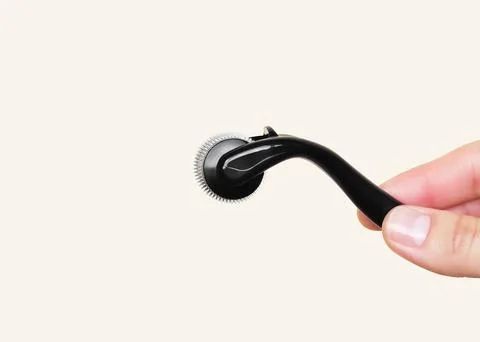 Microneedling Roller Held by Hand Stock Photos