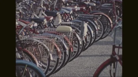 MICRONESIA - 1972: Cycle parking - red bicycles line the roadside 库存影片 343933494