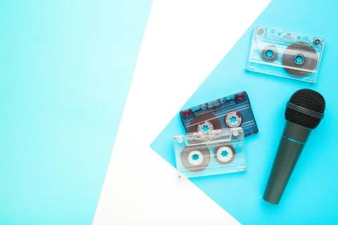 Microphone and cassette on blue background with copy space Stock Photos