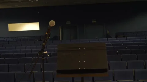 Microphone and lectern on stage looking at empty auditorium seats Stock Footage 341069462