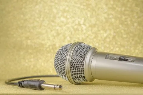 Microphone and plug on a yellow background. Stock Photos