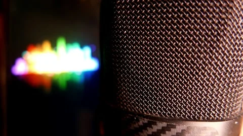 A microphone in an audio recording studio. Sound levels move on a laptop screen Stock Footage 345687693
